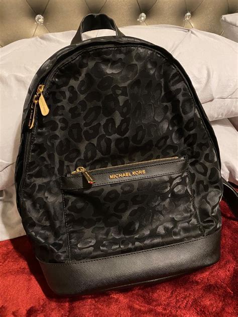 michael kors black leopard backpack.